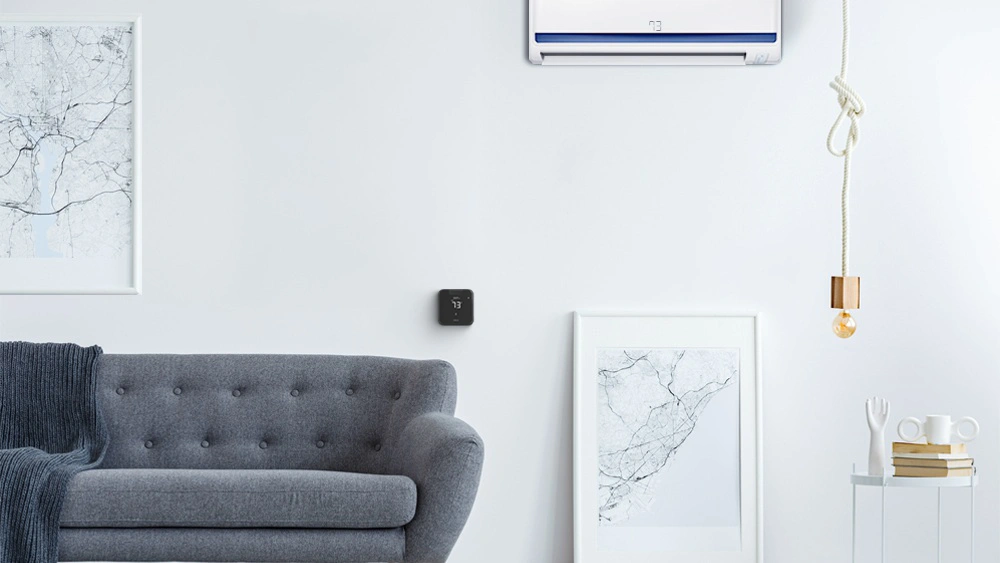 Breez Max, a mini-split thermostat paired with a mini-split unit in a living room