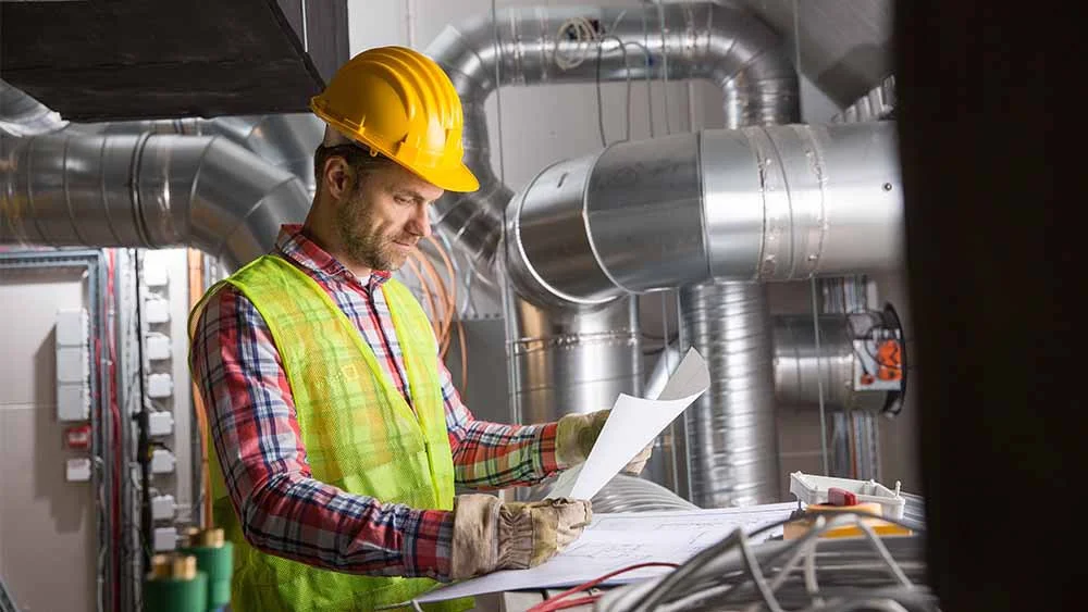 HVAC technician checking notes 