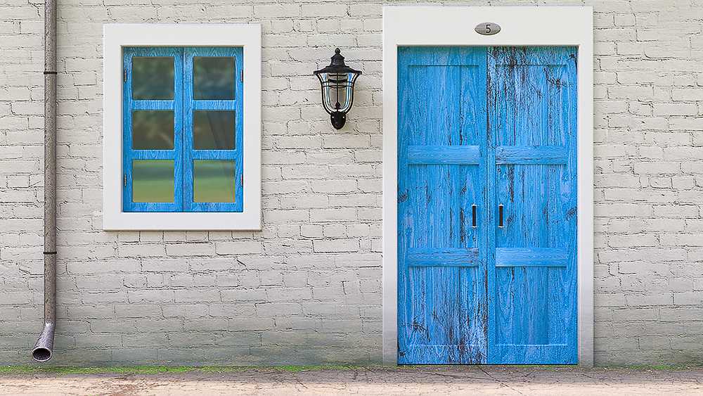 A blue door and a window in an old house