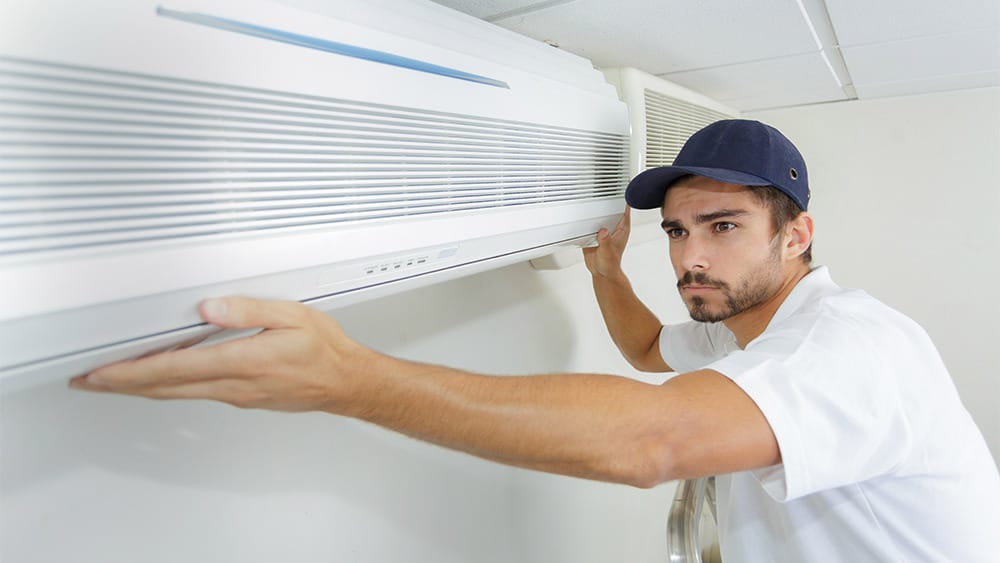Technician fixing the AC.