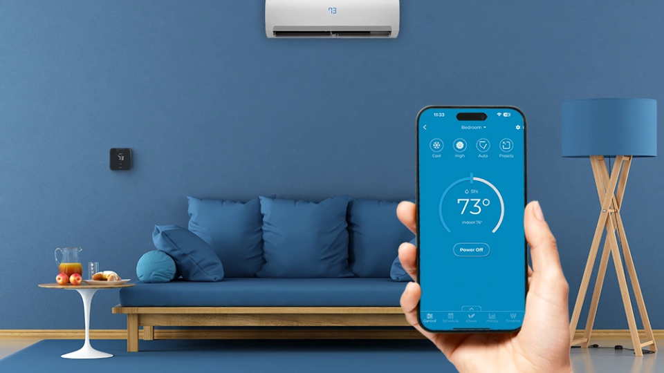 Cielo Breez max installed a living room. A person is using cielo home app to make temperature adjustments