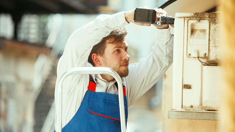 A technician is fixing heat pump