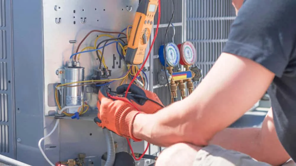 Man fixing air conditioner component.