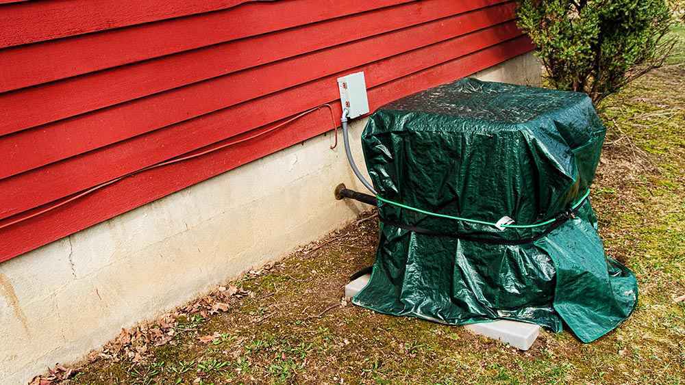 AC outdoor unit covered in water