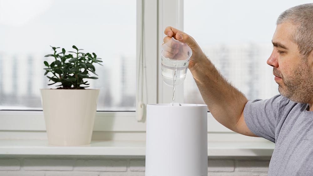 Man refilling humidifier tank
