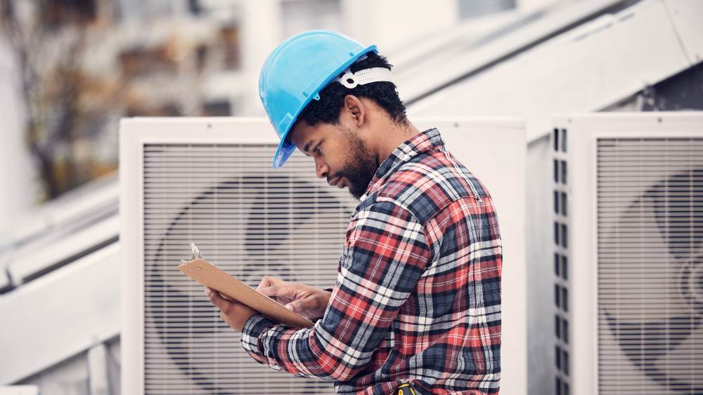 hvac professional checking maintenance needs