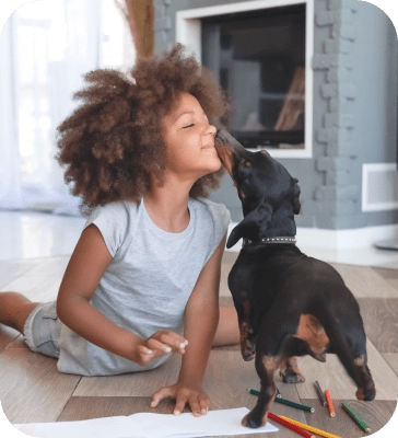 Girl and dog touching noses
