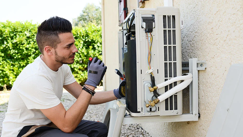 Man checking damaged HVAC system