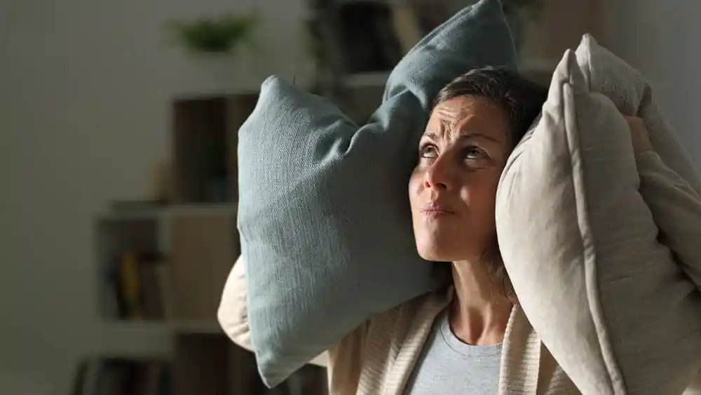 Woman angry at air conditioner noise.