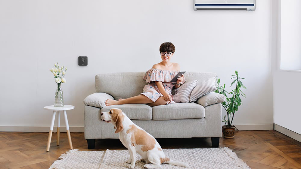 A woman sitting on the couch, using her phone