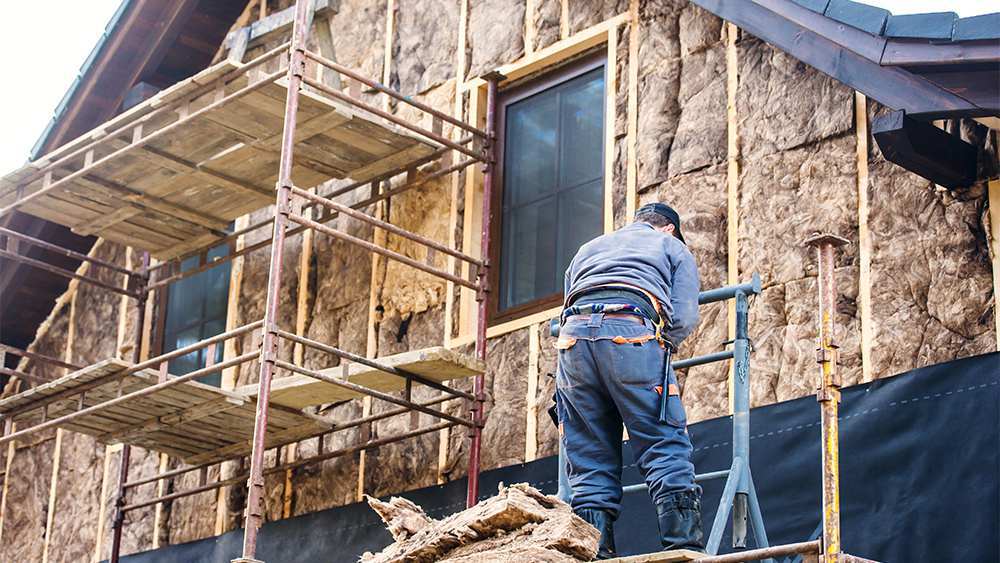 A man installing home insulation