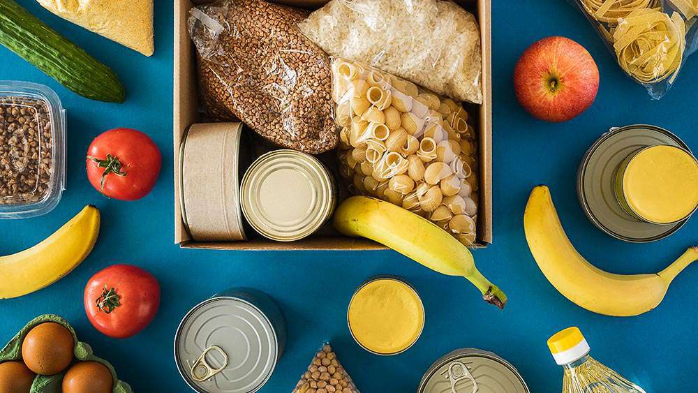 Different food items - pasta, bananas, apples and grains.