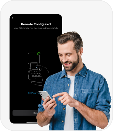 A man is smiling at his phone which displays a message that his AC remote has been paired successfully.