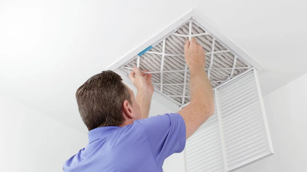a man replacing air filters