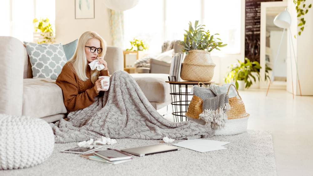 sick woman wrapped in a warm blanket