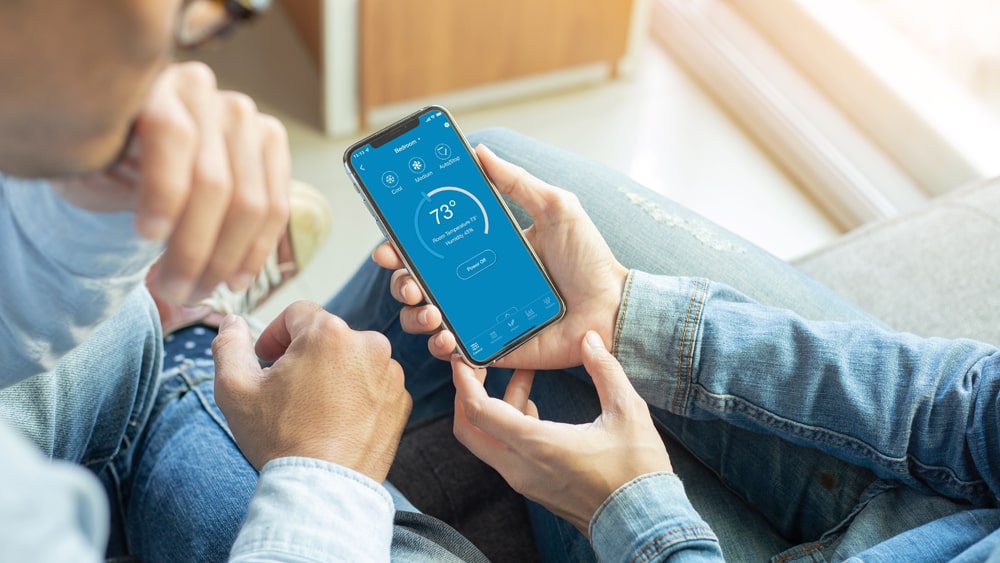 A person using cielo home app to make temperature adjustments 