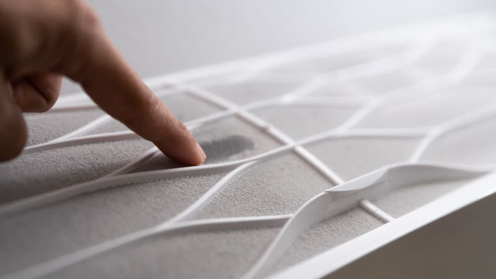 Man checking AC air filter.