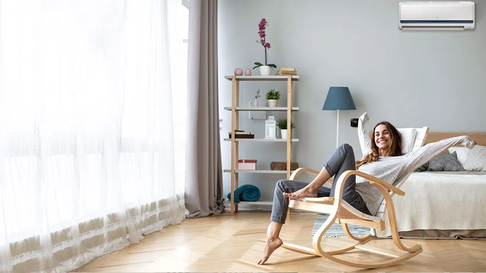 Girl enjoying cool room with Cielo Breez smart AC controller